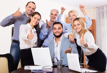 relaxed employees sitting at desk