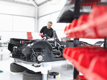 Engineer Assembling Supercar In Sports Car Factory