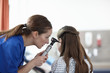 © Connect Images - Nurse using otoscope on girl