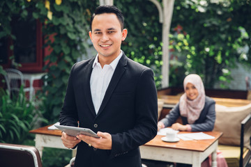 Businessman leader standing in front of his team