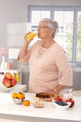 Poster - Elderly woman drinking orange juice