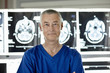 © Connect Images - Portrait of radiologist standing in front of MRI scan