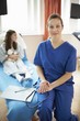 © Connect Images - Nurse sitting on end of patient's bed
