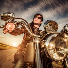 Wall Mural - Biker girl sitting on motorcycle