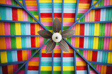 Petal-shaped Fan On Multi-coloured Wooden Ceiling