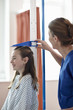© Connect Images - Nurse checking girl's height
