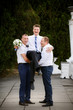 Groomsmen hold the groom at the hands