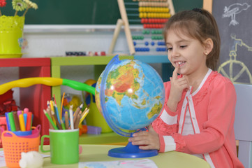 Wall Mural - Beautiful little girl at classroom