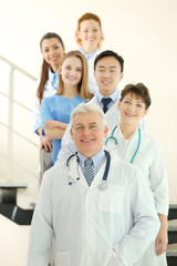 Wall Mural - Team of smiling doctors indoors