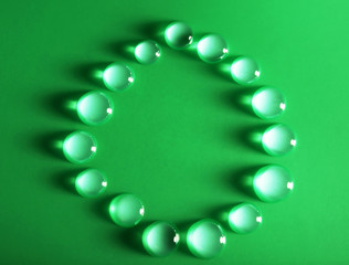 Wall Mural - Water drops on a green surface, top view