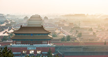 An Aerial Bird View Of The The Famous Forbidden City In Beijing, China. The Vast Area Of The Architectural Complex Is Covered With Evening Mist.