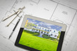 © Andy Dean - Computer Tablet Showing House Image On House Plans, Pencil and Compass