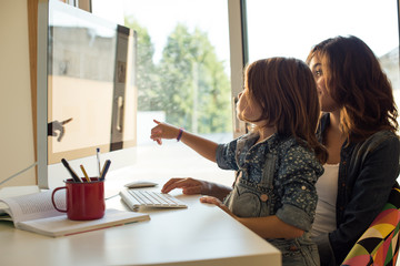 Wall Mural - Mom and daughter using computer