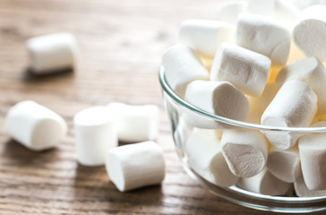 Wall Mural - Bowl of marshmallows on the wooden background