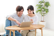 © taka - young asian couple using laptop