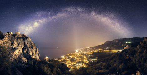 Wall Mural - Beautiful night landscape with Milky Way against city lights