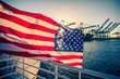 American Flag waving on a boad. Background: beautiful sunset and