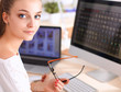 © shefkate - Young woman working in office, sitting at desk