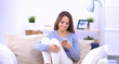 © shefkate - Pretty girl using her smartphone on  couch at home in the living room