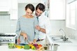 © WavebreakMediaMicro - Couple chopping vegetables at table in kitchen