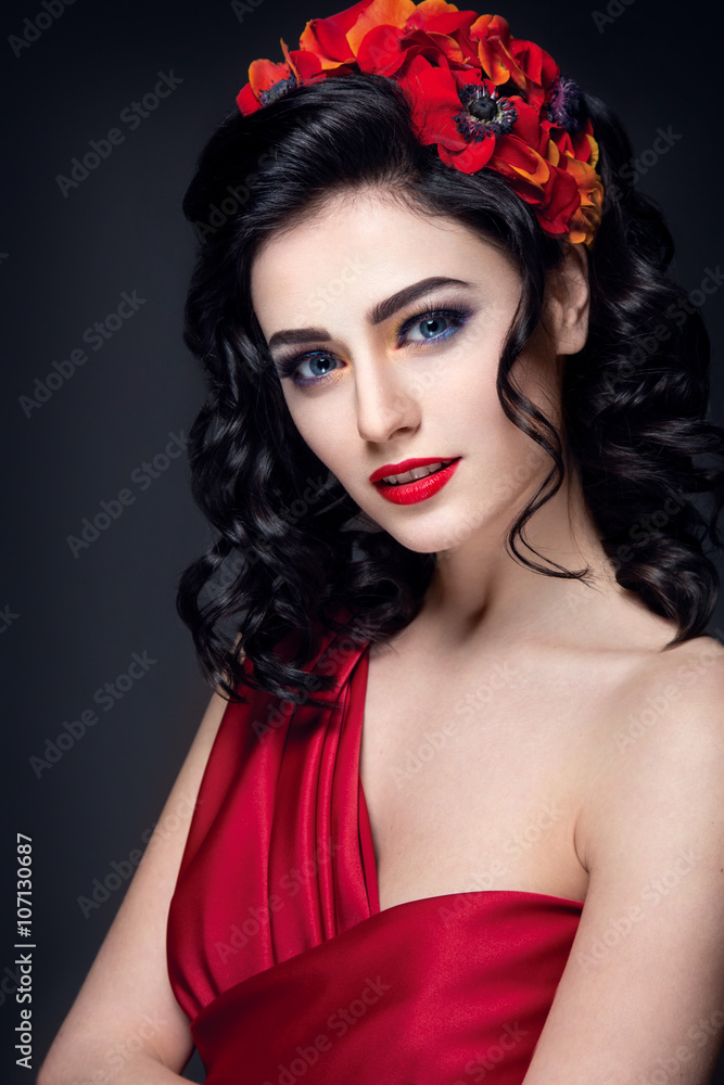 Lady in red. Beautiful woman portrait in red dress, with red lips and  accesoories. Young girl brunette with red flowers in hair. Bright makeup  and nice hairstyle. Stock-bilde | Adobe Stock