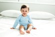 © WavebreakmediaMicro - Cute baby boy sitting on bed at home