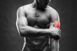 © staras - Pain in the elbow. Muscular male body. Handsome bodybuilder posing on gray background