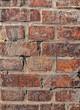 Old red wall with engraved bricks