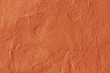 Abstract orange plaster wall texture.