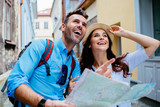 Fototapeta  - Young happy couple on a sightseeing tour in Europe