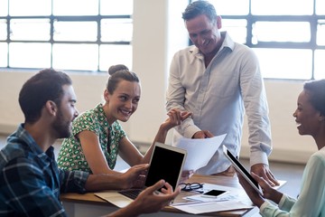 Wall Mural - Young men and women sitting at their desk