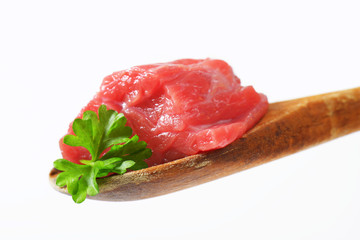 Canvas Print - Raw beef meat on wooden spoon