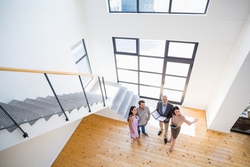 Real estate agent showing new house to couple