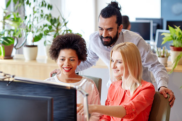 Canvas Print - happy creative team with computer in office