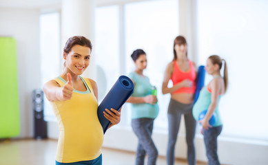 Sticker - pregnant woman with mat in gym showing thumbs up 