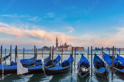 Gondolas moored by Saint Mark square with San Giorgio di Maggiore church in the Plakát