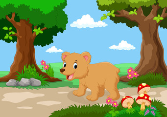 Wall Mural - Funny baby bear with a background of a beautiful garden