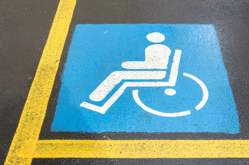 Wheelchair Handicap Sign on dark asphalt road street background- handicap parking place