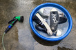 many Shoes and water hose for cleaning