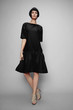 © EVGENY FREEONE - Brunette woman in black dress