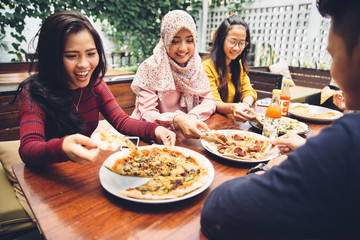 Friends Enjoying Meal In Outdoor Restaurant