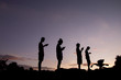 Phubbing, Silhouette of children taking smart phone at sunset sky