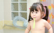 © phaitoon - Little girl brushing teeth in bath
