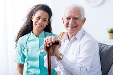 Canvas Print - Young pretty nurse and senior man