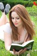 A young attractive woman is reading a book