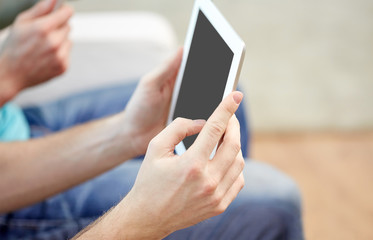 Sticker - close up of male hands with tablet pc at home