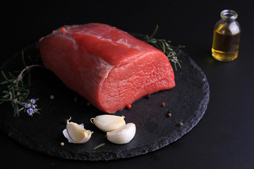 Raw beef meat on black background. Cooking background