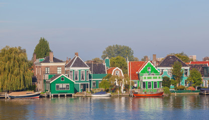 Colourful houses with dutch windmill in Zaaneschans, Netherland