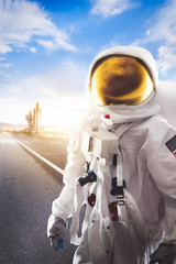 Wall Mural - Astronaut standing on a road