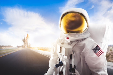 Wall Mural - Astronaut standing on a road